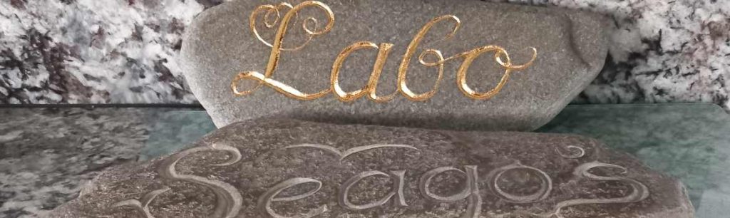 close up of Labo and Seago's - v incised stone letter carving done by hand